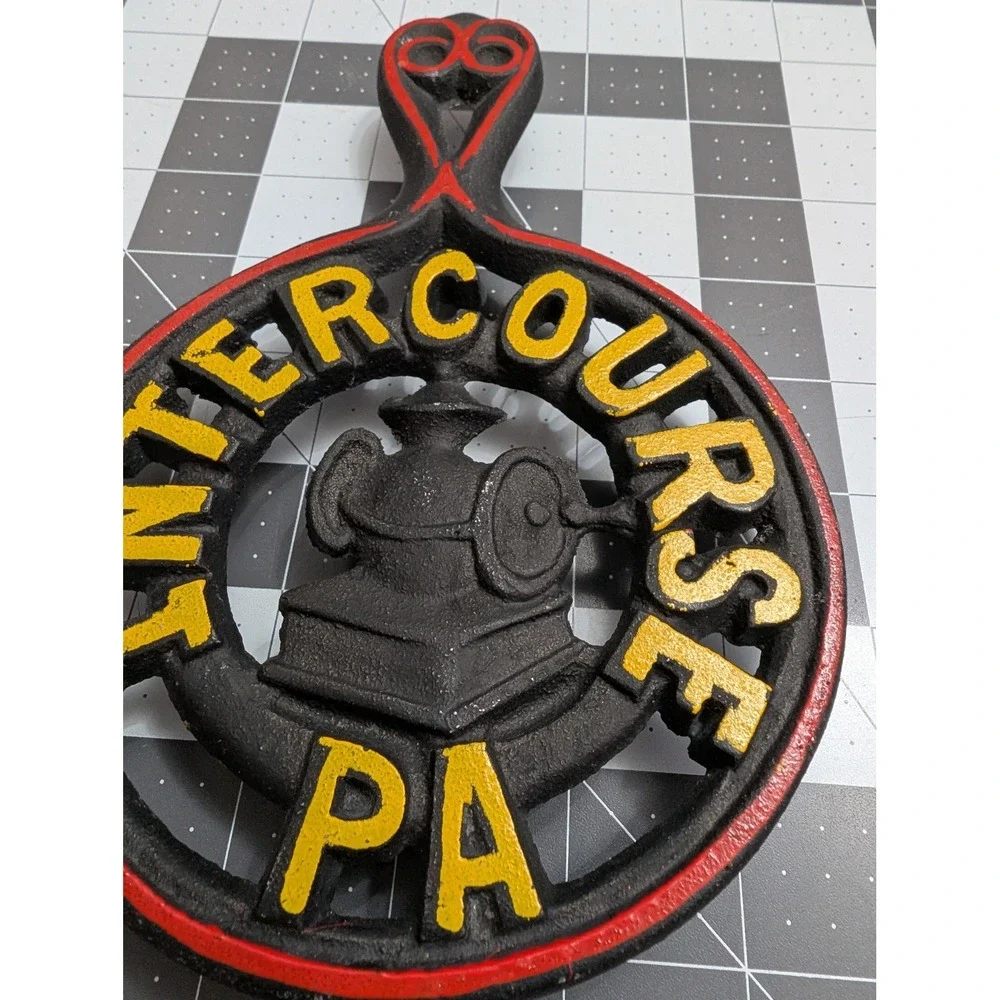 Intercourse PA cast iron footed trivet spoon rest red & yellow painting grain